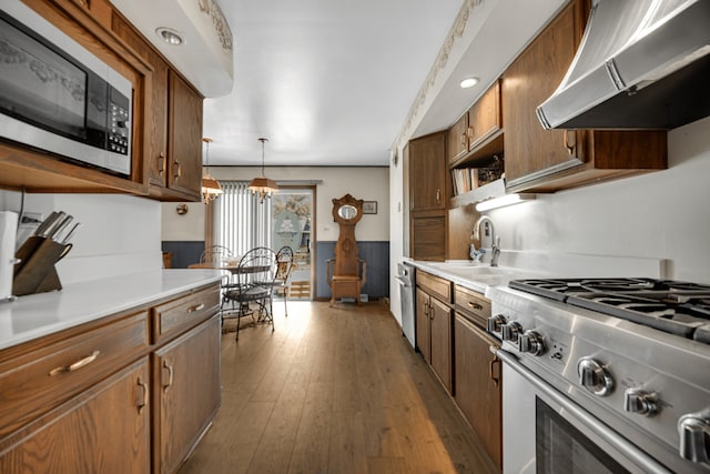 15301 Cherry Ln, Oak Forest, IL 60452 - kitchen featuring wall chimney range hood, high end stove, built in microwave, and light countertops