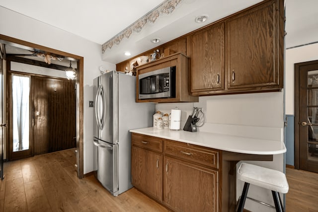 15301 Cherry Ln, Oak Forest, IL 60452 - kitchen featuring appliances with stainless steel finishes, light wood-type flooring, light countertops, and a ceiling fan