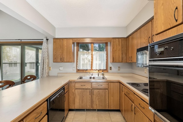 225 Mattek Ct, Dekalb, IL 60115 - kitchen featuring black appliances, light countertops, light tile patterned flooring, and brown cabinetry