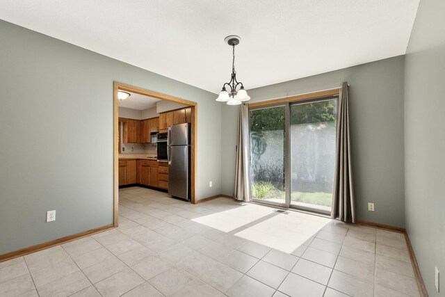 225 Mattek Ct, Dekalb, IL 60115 - spare room with a chandelier and light tile patterned flooring