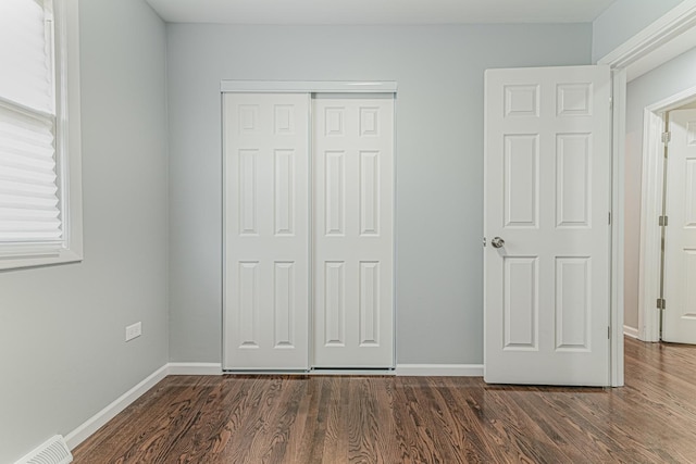 2105 Prospect Ave, North Chicago, IL 60064 - unfurnished bedroom featuring a closet and dark wood-style floors