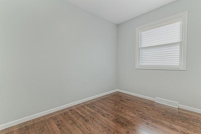 2105 Prospect Ave, North Chicago, IL 60064 - empty room featuring dark wood-style floors and baseboards
