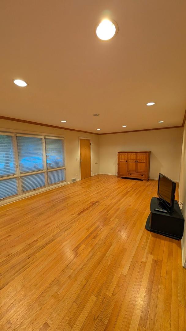 1430 Evergreen Ter, Glenview, IL 60025 - unfurnished living room featuring light wood-style floors and recessed lighting
