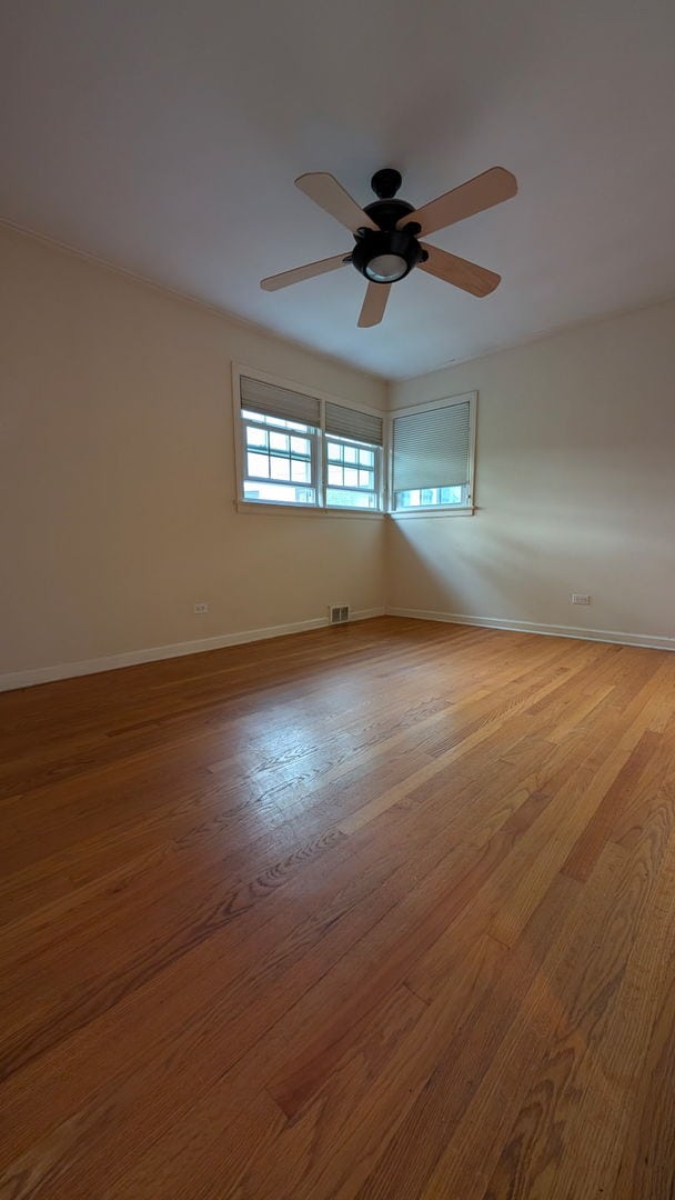1430 Evergreen Ter, Glenview, IL 60025 - spare room with ceiling fan and wood finished floors
