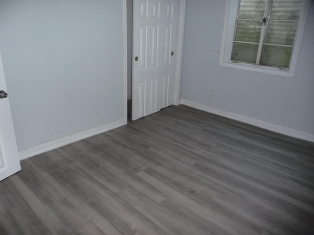 1430 Evergreen Ter, Glenview, IL 60025 - unfurnished bedroom featuring dark wood-style flooring and a closet