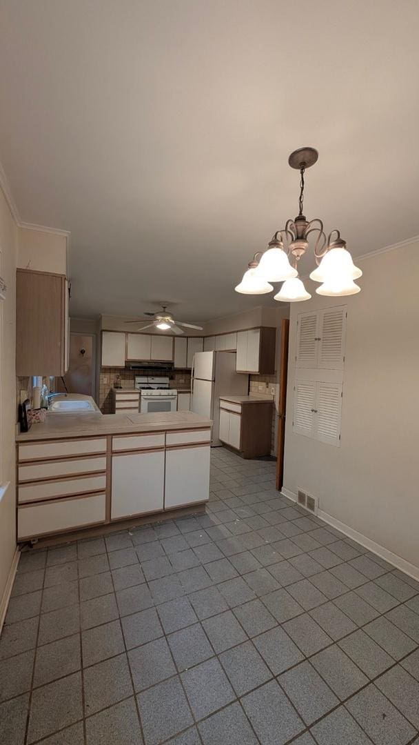 1430 Evergreen Ter, Glenview, IL 60025 - kitchen featuring white appliances, a peninsula, a chandelier, ceiling fan, and decorative light fixtures