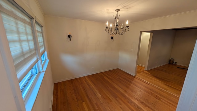 1430 Evergreen Ter, Glenview, IL 60025 - empty room featuring a chandelier, ornamental molding, and wood finished floors