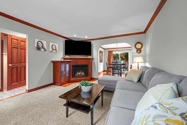 502 Burning Tree Ln, Naperville, IL 60563 - carpeted living room featuring crown molding, arched walkways, a chandelier, a glass covered fireplace, and recessed lighting