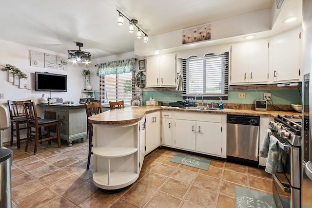 1934 Philip Dr, Dixon, IL 61021 - kitchen with appliances with stainless steel finishes, open shelves, healthy amount of natural light, and white cabinets