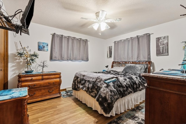 1934 Philip Dr, Dixon, IL 61021 - bedroom with light wood-type flooring, a textured ceiling, and a ceiling fan