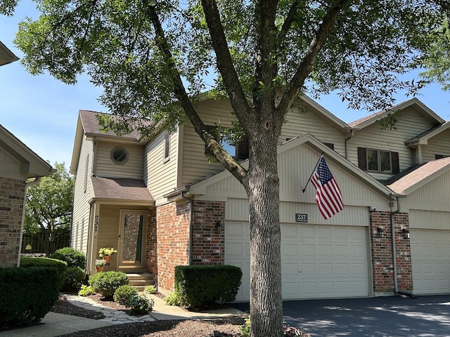 237 Carlisle Ave, Westmont, IL 60559 - view of front of house featuring brick siding, an attached garage, and a shingled roof