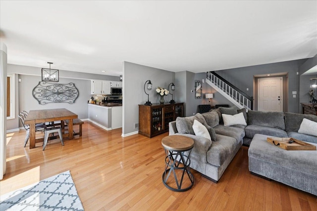 237 Carlisle Ave, Westmont, IL 60559 - living area featuring light wood-style flooring, stairs, and a chandelier