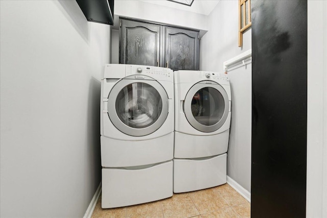 237 Carlisle Ave, Westmont, IL 60559 - washroom featuring cabinet space, washer and dryer, and light tile patterned flooring