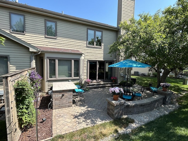 237 Carlisle Ave, Westmont, IL 60559 - back of property featuring a patio area and a chimney