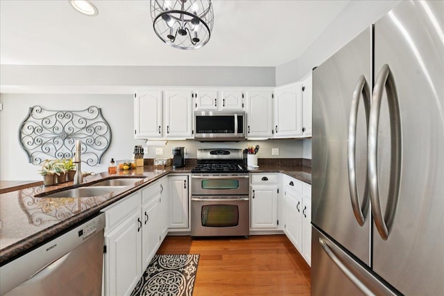 237 Carlisle Ave, Westmont, IL 60559 - kitchen with appliances with stainless steel finishes, white cabinetry, light wood finished floors, dark stone counters, and recessed lighting