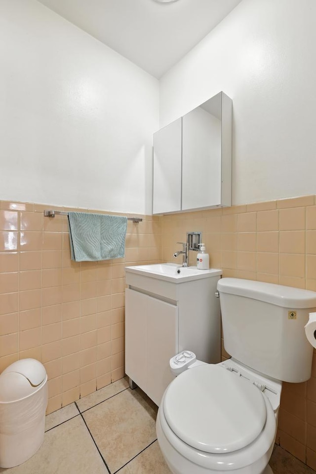 8803 N Grand St, Niles, IL 60714 - bathroom featuring tile walls, vanity, tile patterned flooring, and wainscoting