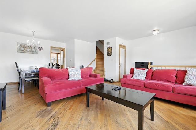 8803 N Grand St, Niles, IL 60714 - living room featuring a chandelier, stairs, and light wood-style floors