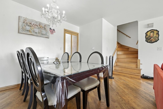 8803 N Grand St, Niles, IL 60714 - dining area with stairs, wood finished floors, and a chandelier