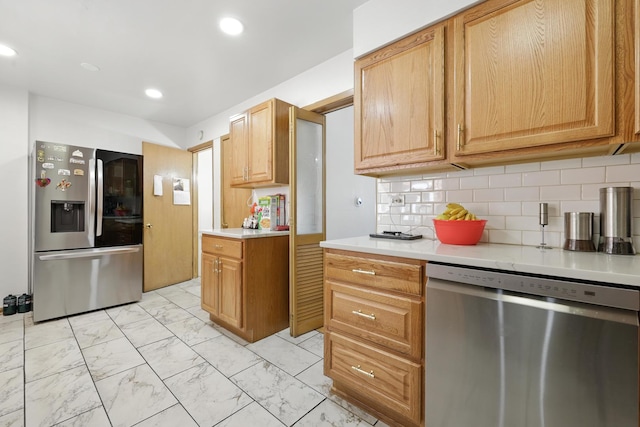 8803 N Grand St, Niles, IL 60714 - kitchen featuring appliances with stainless steel finishes, light marble finish floors, light countertops, tasteful backsplash, and recessed lighting