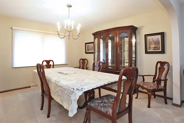 740 Ruskin Dr, Elk Grove Village, IL 60007 - dining space featuring a chandelier, light colored carpet, and arched walkways