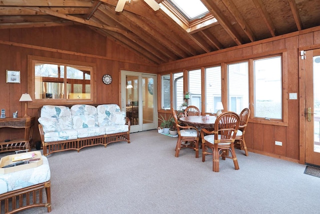 740 Ruskin Dr, Elk Grove Village, IL 60007 - carpeted dining room featuring lofted ceiling, a ceiling fan, a skylight, and wooden walls