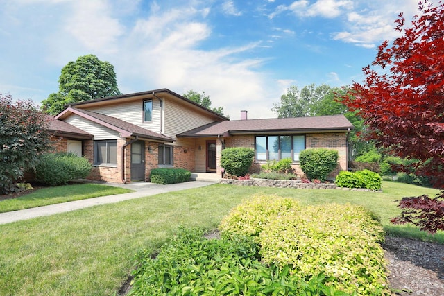 740 Ruskin Dr, Elk Grove Village, IL 60007 - view of front of property featuring brick siding, a front yard, and a chimney