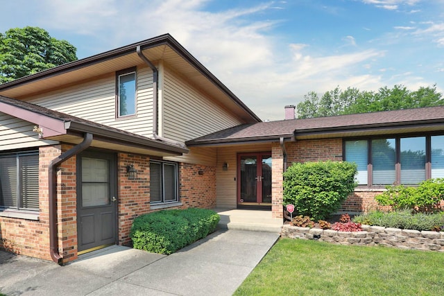740 Ruskin Dr, Elk Grove Village, IL 60007 - view of front of property with brick siding, a chimney, and a front yard