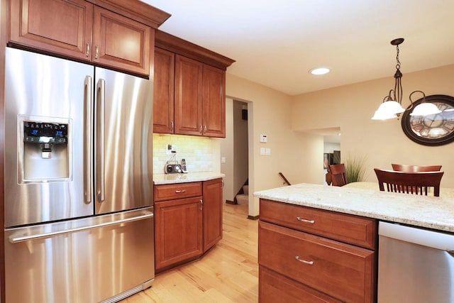 740 Ruskin Dr, Elk Grove Village, IL 60007 - kitchen featuring appliances with stainless steel finishes, light wood-type flooring, brown cabinets, backsplash, and recessed lighting
