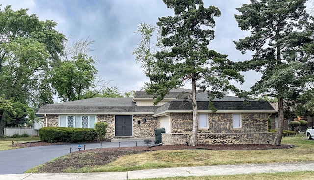 626 E 194th St, Glenwood, IL 60425 - view of front facade featuring a shingled roof, brick siding, and a front lawn