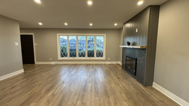 626 E 194th St, Glenwood, IL 60425 - unfurnished living room featuring a fireplace, wood finished floors, and recessed lighting