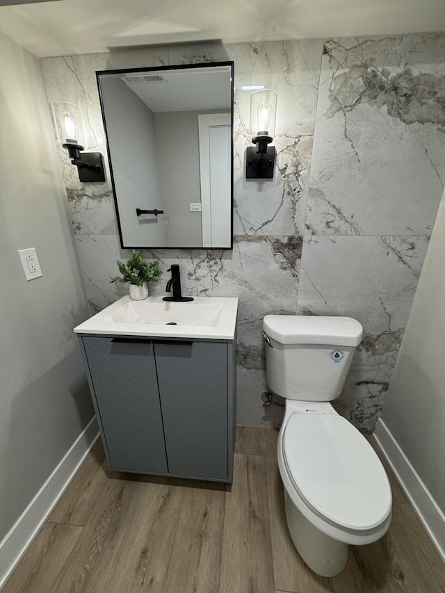 626 E 194th St, Glenwood, IL 60425 - half bathroom featuring vanity, wood finished floors, and tile walls