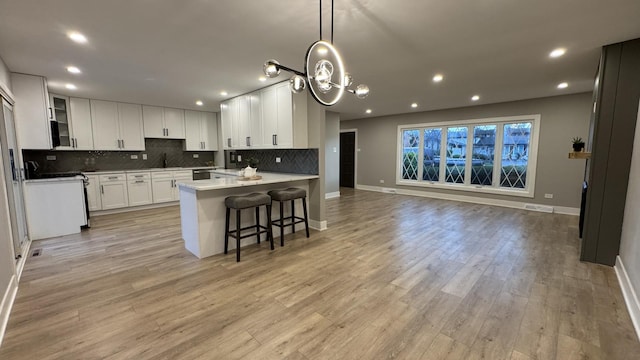 626 E 194th St, Glenwood, IL 60425 - kitchen featuring tasteful backsplash, light wood-style flooring, white cabinetry, open floor plan, and recessed lighting