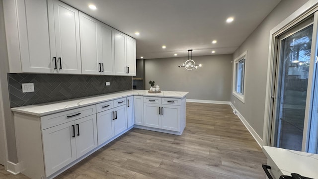 626 E 194th St, Glenwood, IL 60425 - kitchen featuring a peninsula, decorative backsplash, recessed lighting, white cabinetry, and light wood finished floors