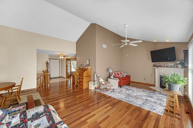 2718 Lake Side Cir, Joliet, IL 60431 - living area with ceiling fan, wood finished floors, a fireplace with flush hearth, and high vaulted ceiling