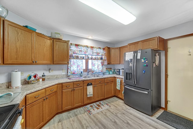 2718 Lake Side Cir, Joliet, IL 60431 - kitchen with appliances with stainless steel finishes, light wood finished floors, brown cabinets, and light stone counters