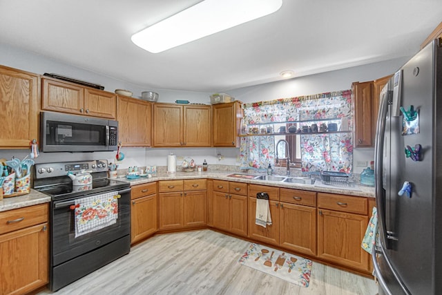 2718 Lake Side Cir, Joliet, IL 60431 - kitchen featuring appliances with stainless steel finishes, light wood-style floors, and brown cabinets