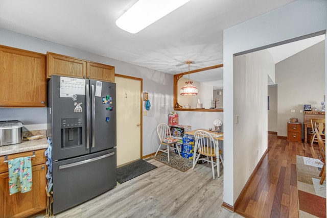 2718 Lake Side Cir, Joliet, IL 60431 - kitchen featuring stainless steel refrigerator with ice dispenser, light wood-style floors, brown cabinets, and hanging light fixtures