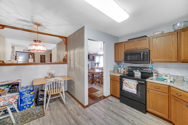 2718 Lake Side Cir, Joliet, IL 60431 - kitchen featuring black range with electric stovetop, light wood-type flooring, and brown cabinetry