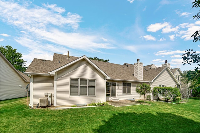 2718 Lake Side Cir, Joliet, IL 60431 - rear view of house featuring a yard, a patio, roof with shingles, and a chimney