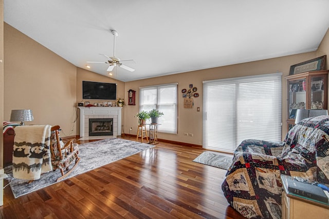 2718 Lake Side Cir, Joliet, IL 60431 - living area featuring wood finished floors, a ceiling fan, lofted ceiling, and a tiled fireplace