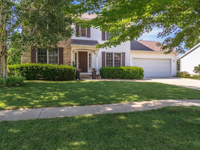 2805 Polo Rd, Bloomington, IL 61704 - view of front of home featuring driveway, an attached garage, a front yard, and a shingled roof
