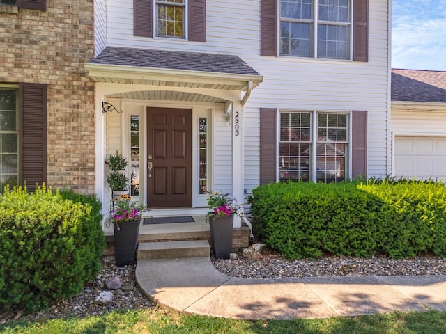 2805 Polo Rd, Bloomington, IL 61704 - view of exterior entry featuring a shingled roof and brick siding