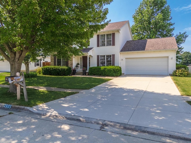 2805 Polo Rd, Bloomington, IL 61704 - view of front facade with a front yard, an attached garage, and driveway