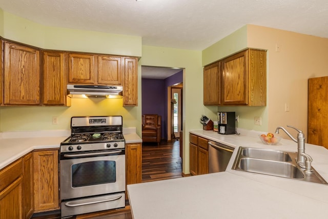 2805 Polo Rd, Bloomington, IL 61704 - kitchen featuring stainless steel appliances, under cabinet range hood, dark wood-style flooring, light countertops, and a textured ceiling