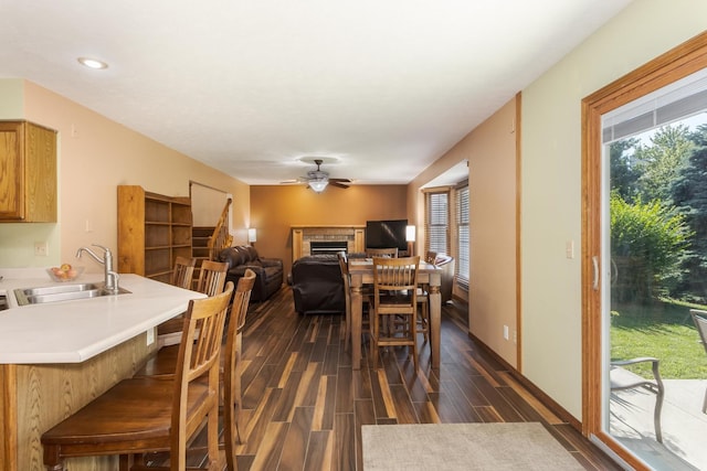 2805 Polo Rd, Bloomington, IL 61704 - dining space with a fireplace, a ceiling fan, dark wood-style flooring, and recessed lighting