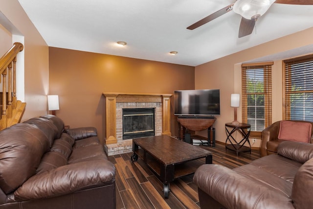 2805 Polo Rd, Bloomington, IL 61704 - living room featuring dark wood finished floors, ceiling fan, stairway, and a fireplace