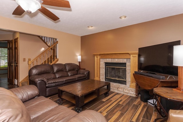 2805 Polo Rd, Bloomington, IL 61704 - living area featuring stairway, a ceiling fan, a brick fireplace, and dark wood-type flooring