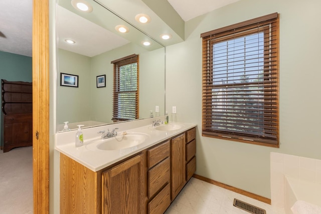 2805 Polo Rd, Bloomington, IL 61704 - bathroom with double vanity, a bath, and recessed lighting