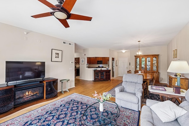 940 Augusta Way Unit 315, Highland Park, IL 60035 - living area with light wood-type flooring, a ceiling fan, and a glass covered fireplace