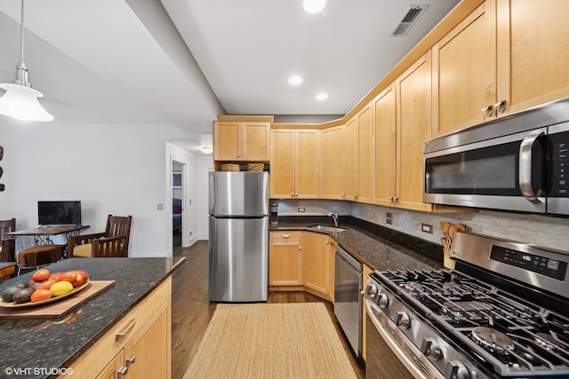 7639 N Greenview Ave Unit 1E, Chicago, IL 60626 - kitchen featuring stainless steel appliances, light brown cabinetry, wood finished floors, dark stone countertops, and decorative backsplash